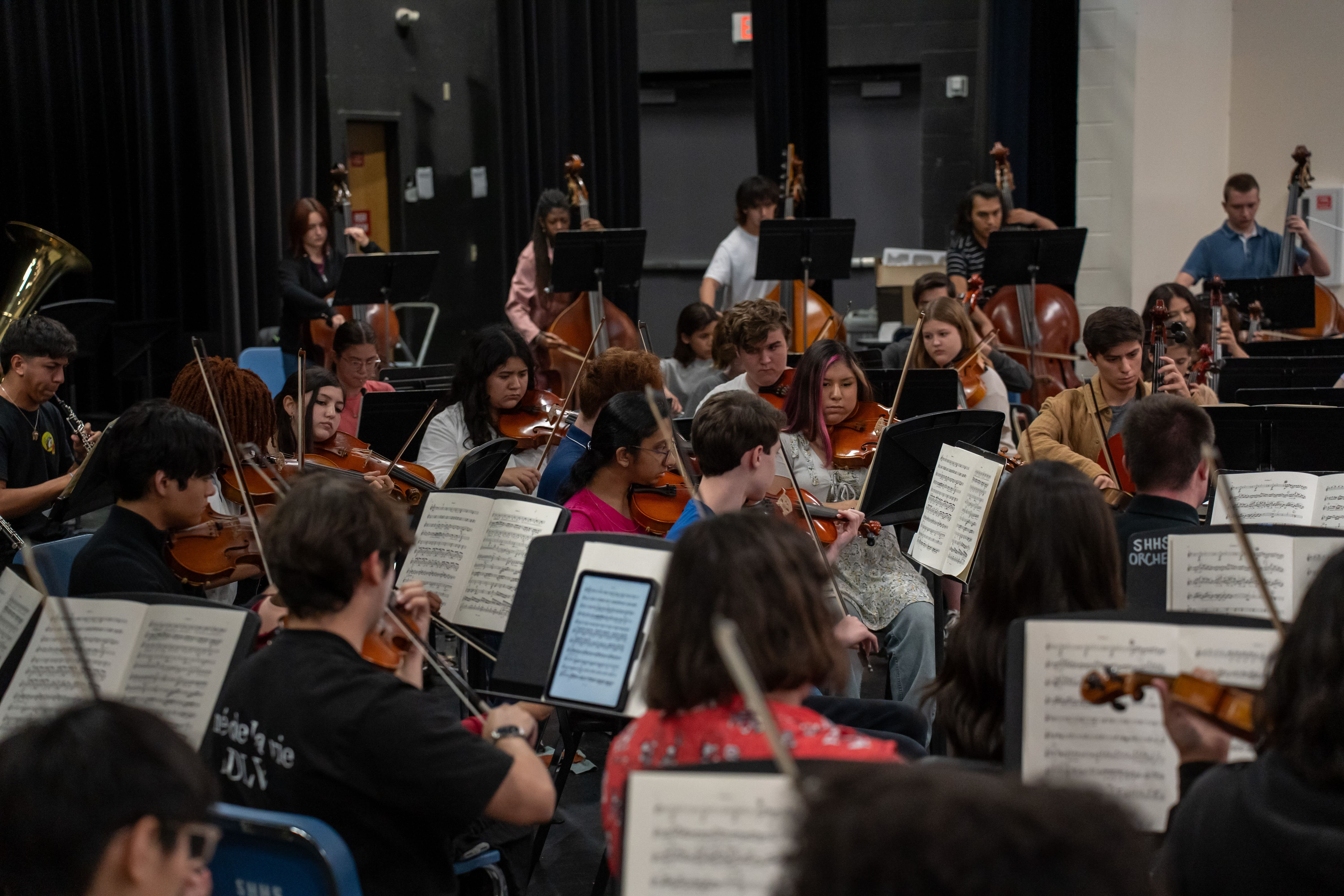 TXIOS OrchestraFest students rehearsing with conductor